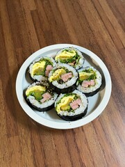 Delicious kimbap rolls filled with fresh vegetables, seasoned rice, and savory proteins, all wrapped in crisp seaweed. A perfect combination of flavor and texture in every bite.