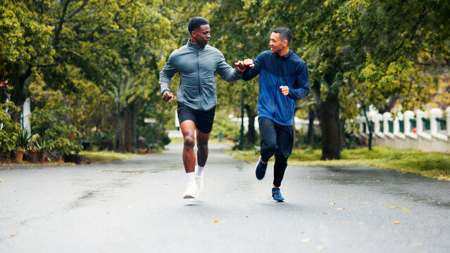 Fitness, running and people with fist bump outdoor for marathon training, challenge success and race celebration. Friends, team building and runner club with workout progress, sports support and jog