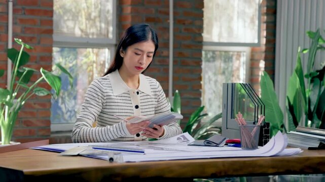 Portrait of pretty female interior professional designers working confidently making some sketches while using graphic tablet at creative modern workplace office