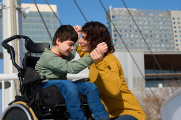 Happy child with disability interacting with mother outdoors