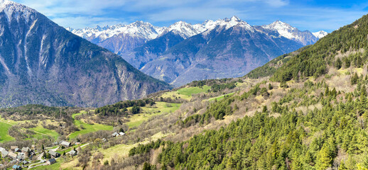 Mountain landscape with snow capped peaks and lush green valley Maurienne Valley in France