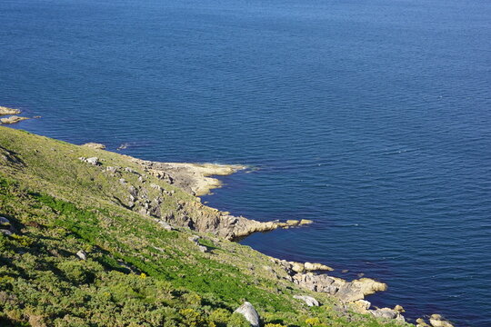 cliffs with grass and stones next to the ocean, nature in its purest state.