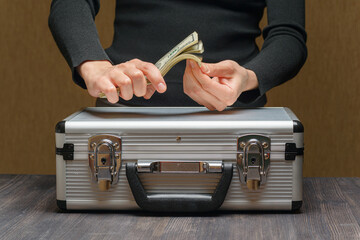 Closeup view of money case and female hands counting cash