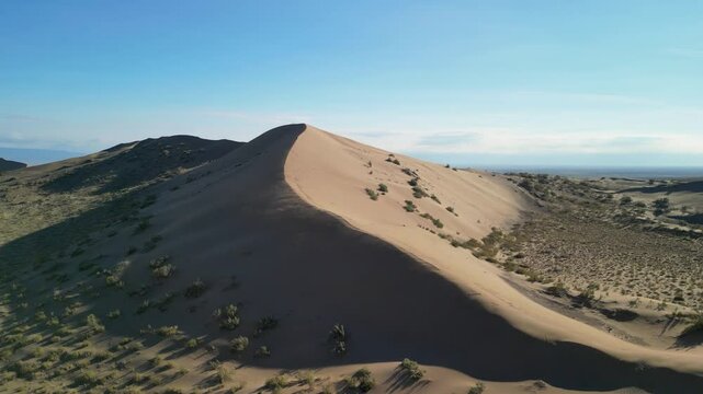 A natural wonder of Central Asia &mdash; the Singing Dune in Kazakhstan, where shifting sands create a low-frequency "singing" noise. Aerial perspective shows the dune and its vast surroundings.