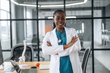 In white coat. Female doctor in coat is in the office clinic