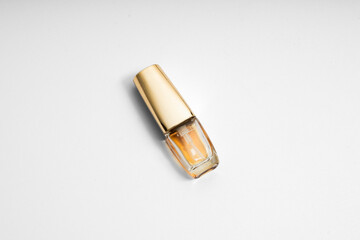Perfume bottle on yellow and white backgrounds with a glass container and liquid scent