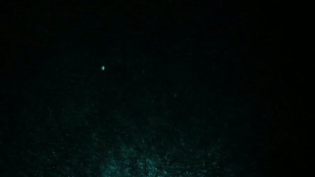 Dark underwater scene with mysterious deep sea particles and subtle light