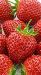 Luscious ripe strawberries glistening with summer's sweetness, a vibrant red cluster showcasing juicy perfection in close-up detail.