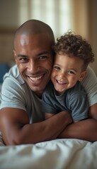 Fototapeta premium A beaming father and his young son share a heartwarming moment, cuddled together on a cozy bed. Their infectious smiles radiate love and happiness, capturing the essence of family bonding and joyful