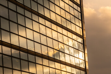 Abstract grid of golden windows reflecting sky with subtle distortion and dynamic lighting