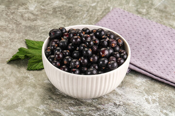 Ripe black currant in the bowl