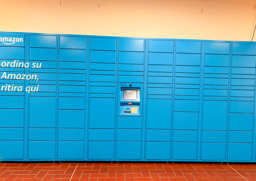 Amazon locker station with blue parcel units inside Citt&agrave; Fiera shopping mall in Udine, Italy
