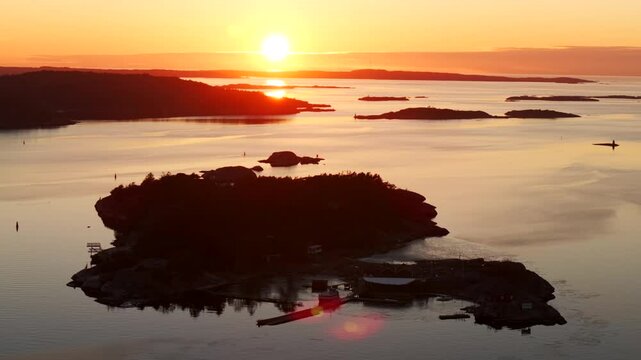 Str&ouml;mstad Stromstad Sweden aerial drone Scandinavia Arctic Circle sea islands golden sunset sun rays on horizon peaceful calm still Sandelfjord Fjord Skagerrak Baltic marina harbor circle right