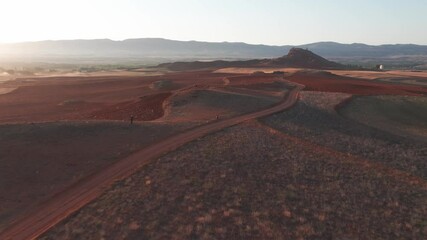 drone shot over road with hills in summer aragon spain