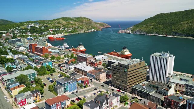 A slow fly over Duckworth street in St. John's, Newfoundland, Canada on a Summer day displaying the harbour and Signal Hill.