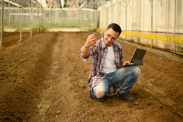 Farmer inspecting soil texture and composition, preparing for planting