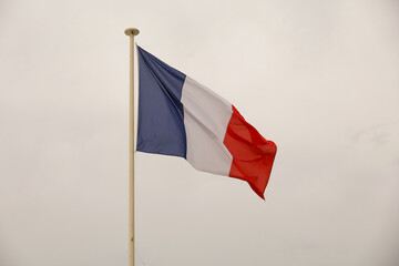 The flag of France flutters in the wind.