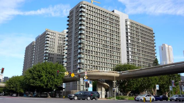 Los Angeles, California - January 7, 2025:Street view of the Skye at Bunker Hill apartments complex, showcasing modern architectural design in downtown LA with traffic and greenery