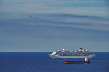 Mega family cruiseship cruise ship liner Favolosa and bunker ship anchored offshore of...