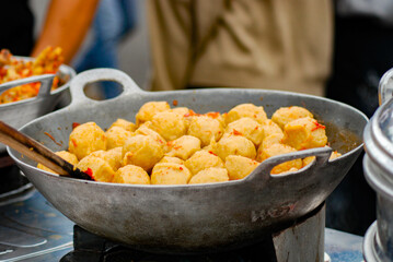 cooking fried meatballs directly in a hot frying pan, Fried meatballs are street food