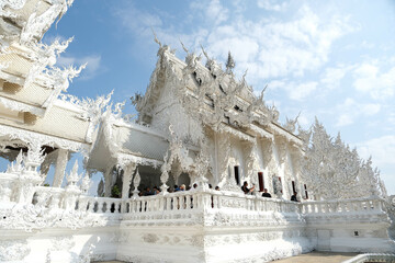 Architecture of main ubosot at Wat Rong Khun (The White Temple), white church with outstanding art in Thailand