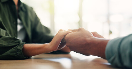 Obraz premium Care, comfort and couple holding hands for love, loyalty and connection in home on table. Support, kindness and people closeup for empathy, forgive partner and commitment for relationship together