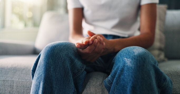 Hands together, psychology and woman on couch, anxiety and stress with depression. Closeup, therapy room or person with counselling, worry or mental health with emergency, trauma or nervous with ptsd