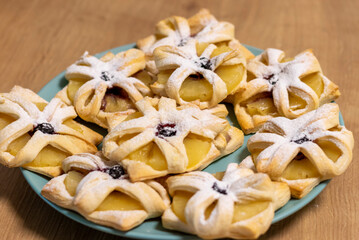 Freshly baked fruit puff pastries on the ceramic plate. Baking