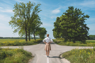 indecisive woman standing at crossroad unable to make decision about future path and to choose the right direction