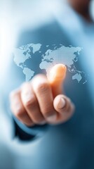 A hand is touching a digital world map, symbolizing interaction with technology and global connectivity.