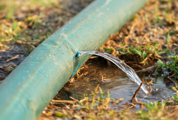 Water leaking from hole in a industrial hose.