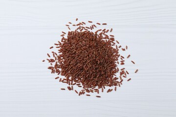 Pile of brown rice on white background