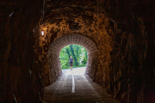 Hiker walking through a tunnel near Walensee in Switzerland