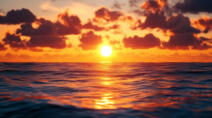 Obraz premium As the sun descends into the horizon, brilliant hues of gold and orange spill across the sky, reflecting on calm ocean waters, creating a serene atmosphere as day transitions to night