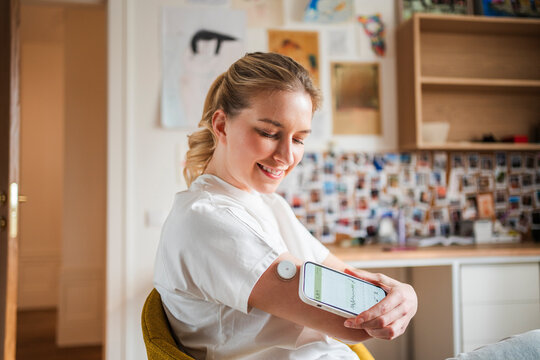 Young woman diabetes, measures glucose, health, bedroom, home, diabetes, sensor, sugar control