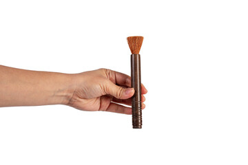 Hand using a little paintbrush isolated on a transparent background