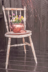 flower vase on vintage chair
