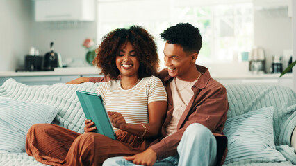 Tablet, excited and couple on sofa in home with planning romantic vacation, holiday or getaway. Happy, digital technology and man with woman for booking flights for honeymoon trip in apartment.