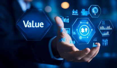 Businessman touching a virtual hexagon with the text value and icons of money and human resources in the background. This business concept represents technology business growth or a social group