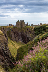 Fototapeta premium Dunnottar Castle rises in dramatic ruins atop a cliff overlooking the North Sea. Its breathtaking views, rich history, and rugged beauty make it one of Scotland’s most iconic and cinematic locations.