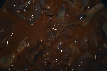 Tender marinated pieces of meat simmer in a flavorful sauce, creating a mouthwatering aroma in the kitchen, ready for a delicious meal