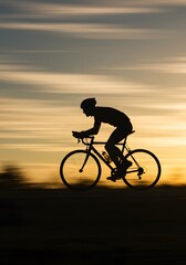 Silhouette of a Cyclist Riding at Sunset