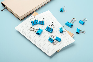 Checklist paper with binder clips on office table background