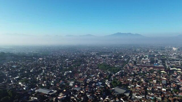 A rotating aerial drone video of a town from a high altitude.
