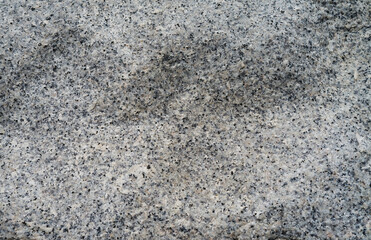 Gray granite stone, rough surface of piece of stone background, texture of rocky surface