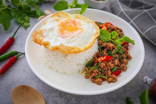 Homemade Rice topped with stir fried Thai basil with minced pork and fried egg, pad ka praow moo sap