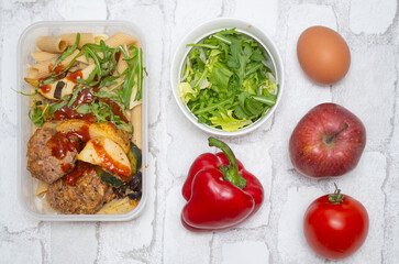 Top view of a healthy and delicious lunchbox with vegetables, fruits, and meat—perfect for work meals, meal prep, and eating healthy on the go. Ideal for fitness, wellness, and diet-focused content.