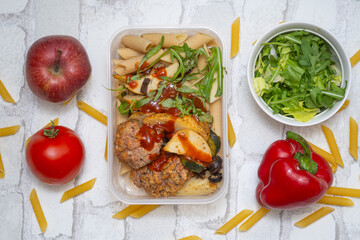 Balanced and tasty lunchbox next to fresh fruits and vegetables—perfect for healthy eating, calorie counting, and meal prep inspiration. Ideal for wellness, fitness, and nutrition-focused content.