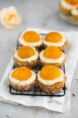 Lemon cupcakes with cream cheese, apricot and poppy seed. Cupcake in form of Fried Egg on a stone background. Easter eggs. Easter holiday and festive food.