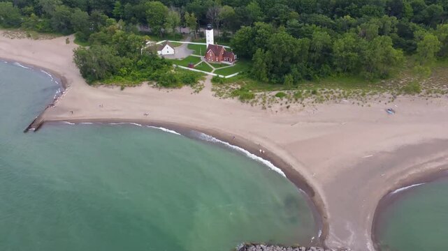 Fly over Presque Isle to witness its sun-kissed beaches, the deep blue of Lake Erie, and the dense green forests framing this scenic Pennsylvania gem.